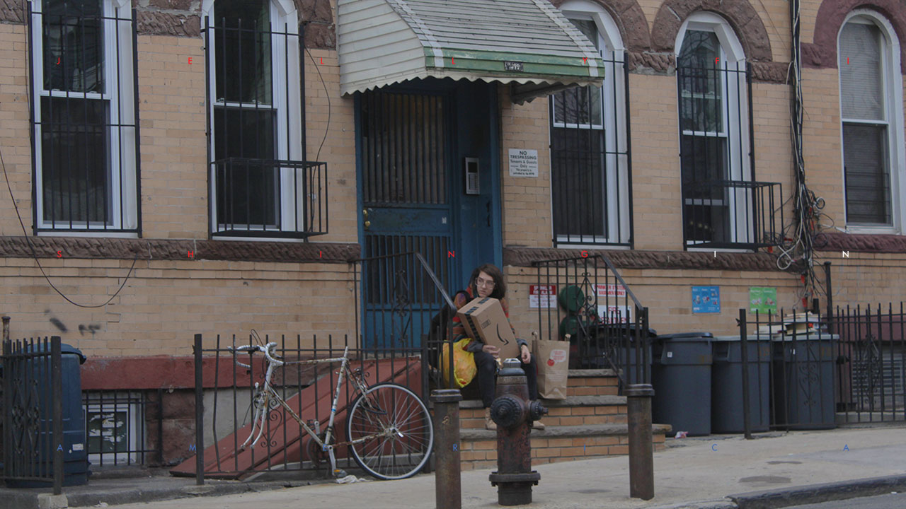 Eleni Kontos rests in front of a Bushwick apartment