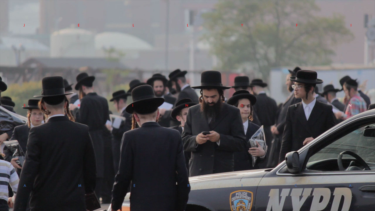 Noah Sparkes checks his phone during Yom Kippur